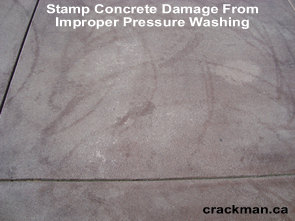 On this concrete driveway, notice the damage caused to the stamp concrete from incorrect use of a pressure washer.
